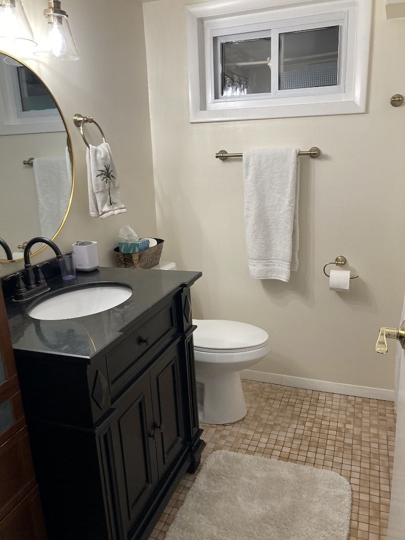 Bathroom with new hardware and mirror.