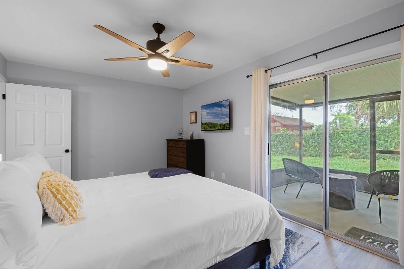 Master suite with king bed, access to backyard and enclosed patio.