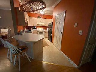 Step-saver kitchen with total electric appliances and large pantry.