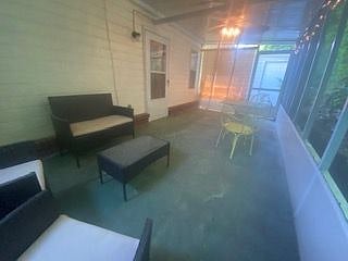 So private and serene a screened in back patio with outdoor strung lights and comfortable seating for reading or dining.