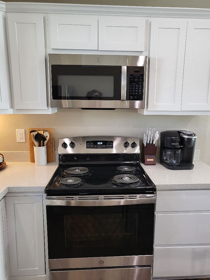 GE Microwave and stove, cooking utensils and coffee maker
