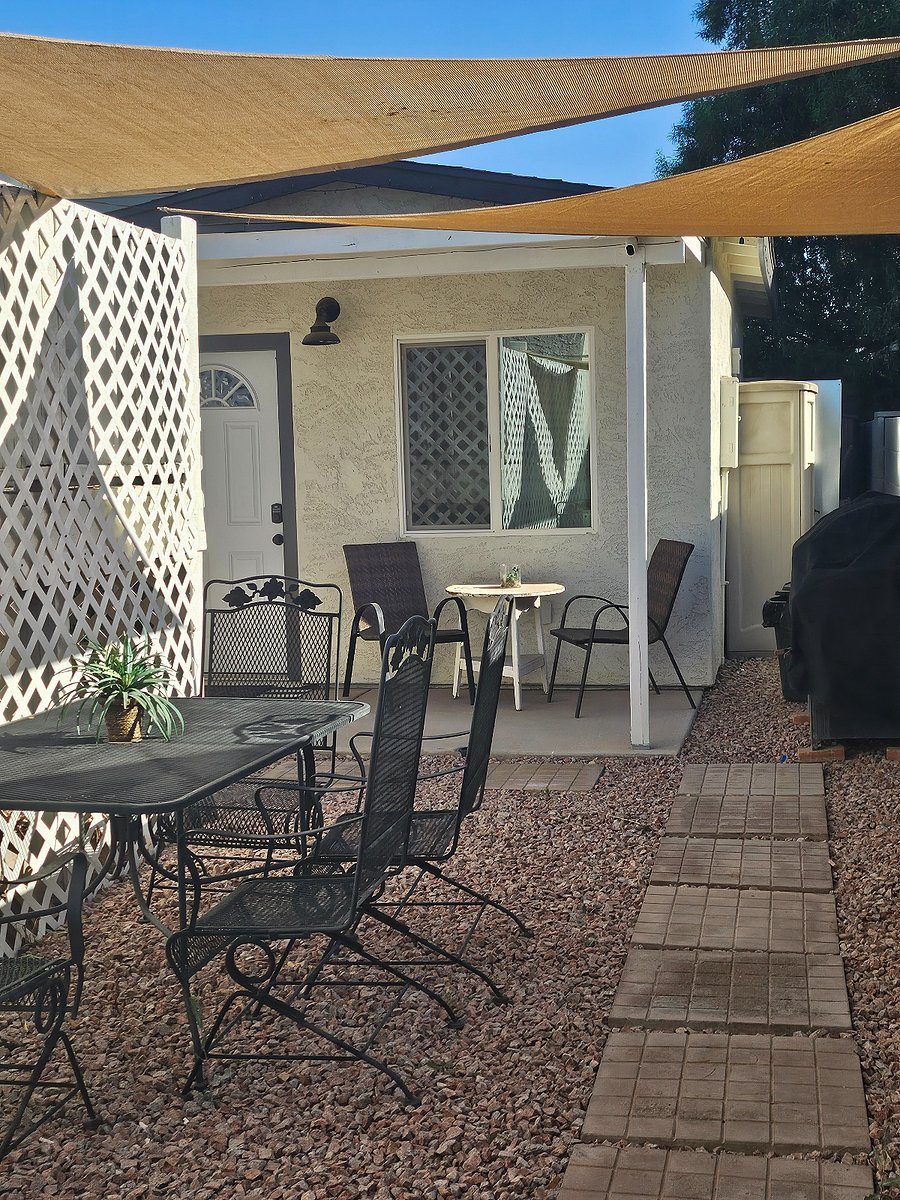 Sitting area covered with sun sail to enjoy morning coffee or even wine