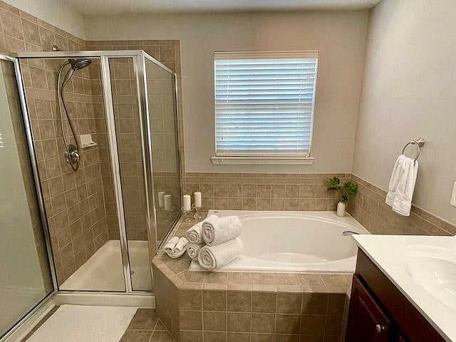 A large bathroom is all yours, with soaking tub, shower, and double vanity.