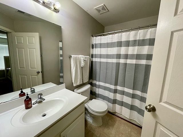 Full bathroom with tub and tiled shower, accessed from the hallway next to your bedroom.