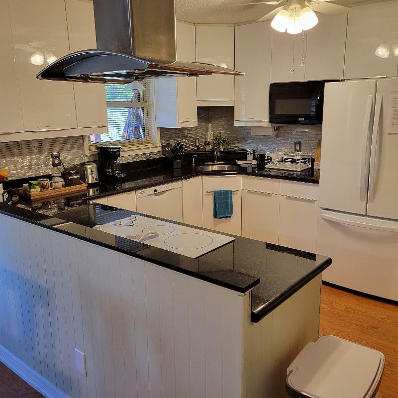 Full Sized Kitchen with stove and oven with hood, microwave, refrigerator and dishwasher.