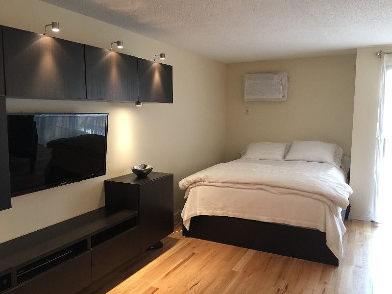 Queen bed is always set up but does not encroach into the living area.