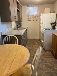 Kitchen area with full size frig and stove. Shelf over stove with microwave is being added.