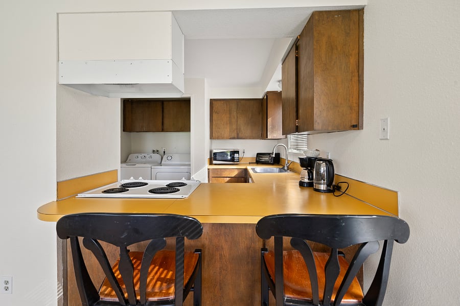 Kitchen view with a couple bar stools.