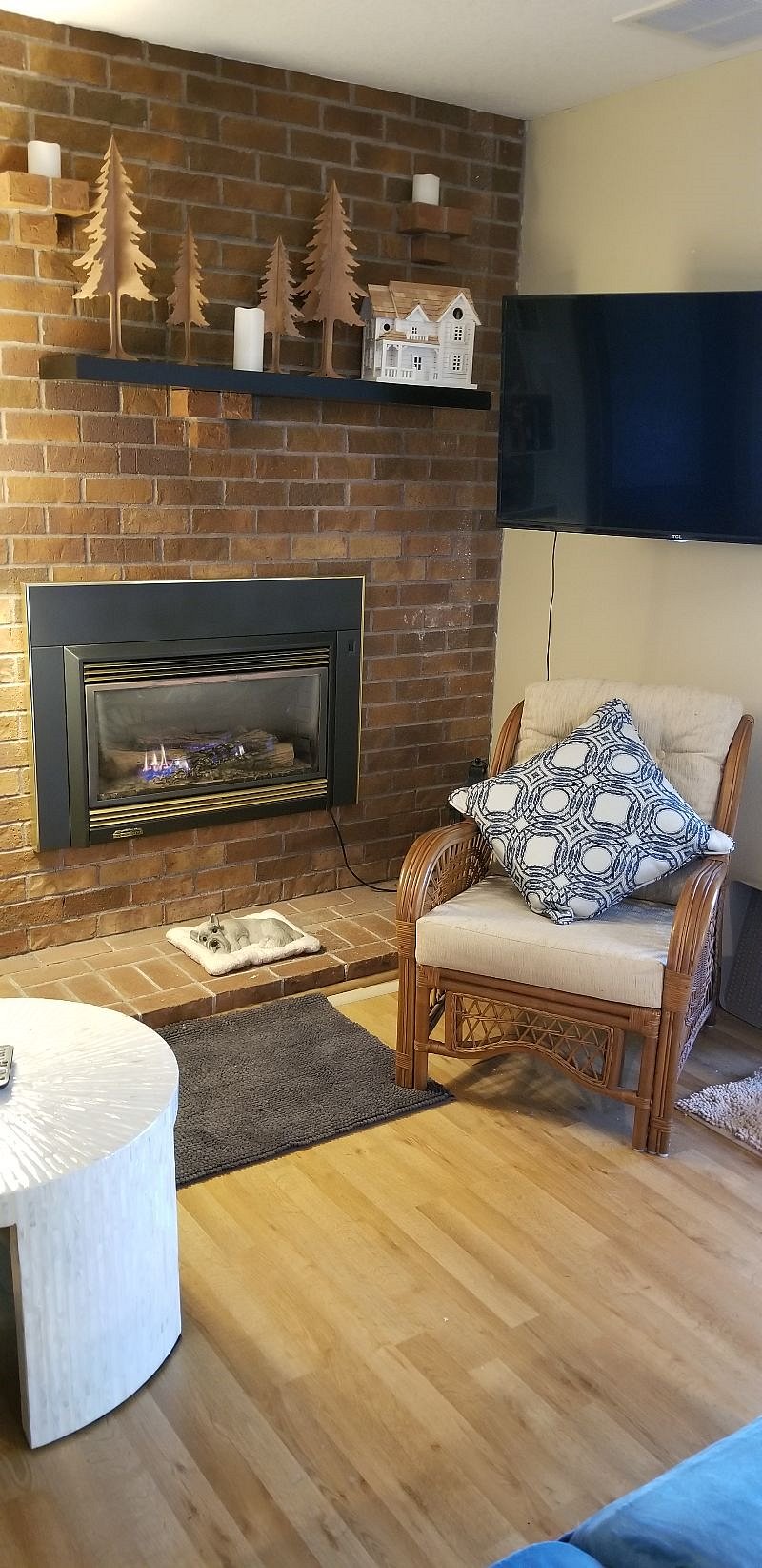 Living room with recliner and wicker chairs.