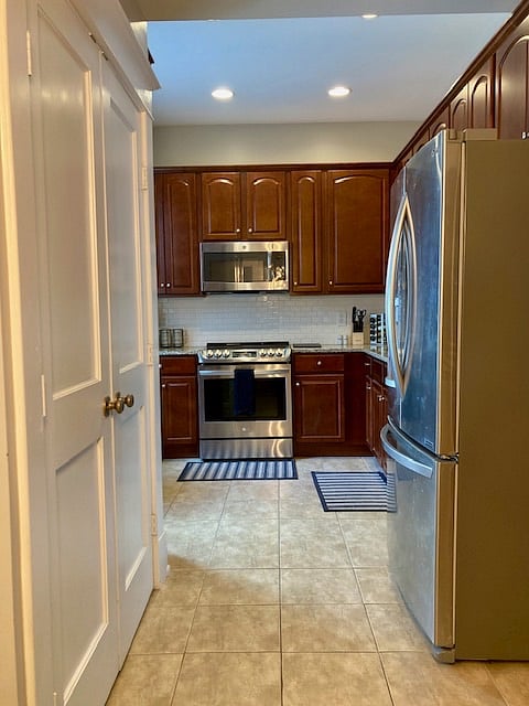 Kitchen is fully stocked with cooking items and spices.