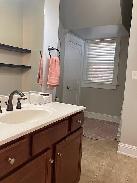 Second full bathroom, located off kitchen, with shower/tub and single vanity. 
