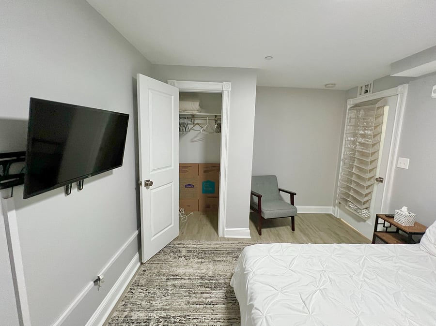 View of bedroom closet and wall mounted TV