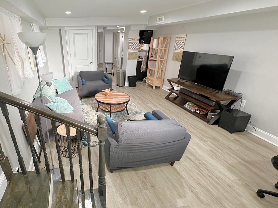 View from private door entrance: living room, kitchenette visible on far right corner.