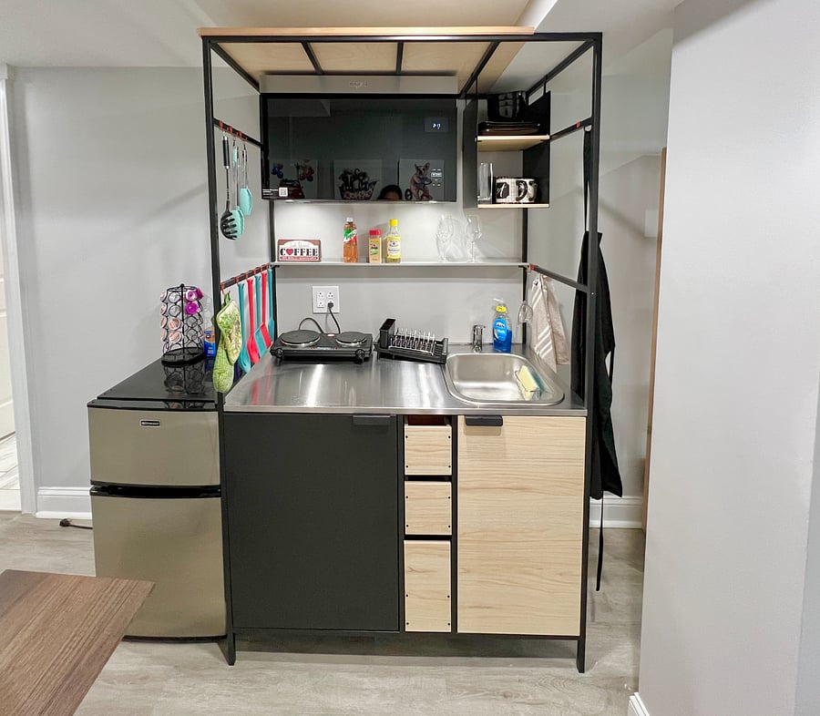 Fully equipped kitchenette with warm and cold water. New over-the-range microwave. (Includes air fryer and coffee pot not seen in picture)