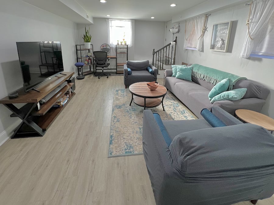 Living room with smart TV. Office space with desk and bookshelf. Lots of natural light.