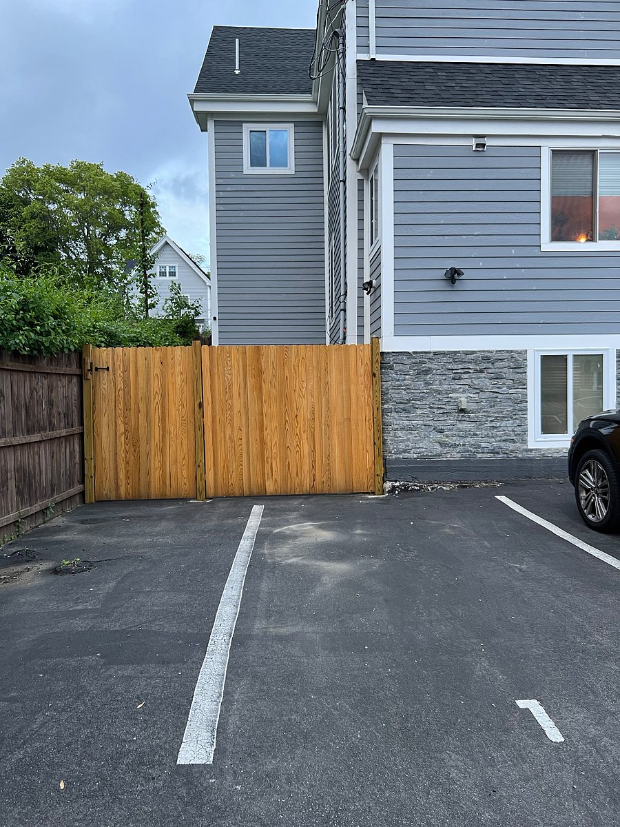 Private parking spot on driveway. Apartment entrance on the other side of fence.