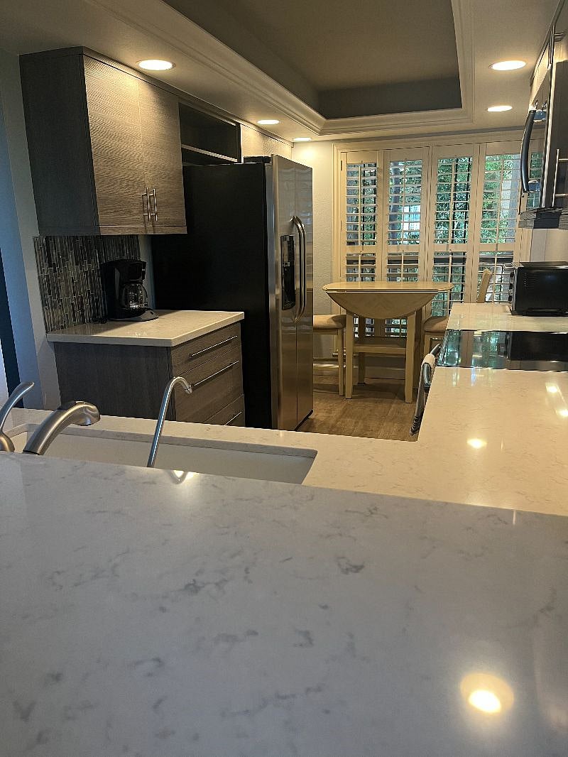 updated kitchen with bar overlooking the living space