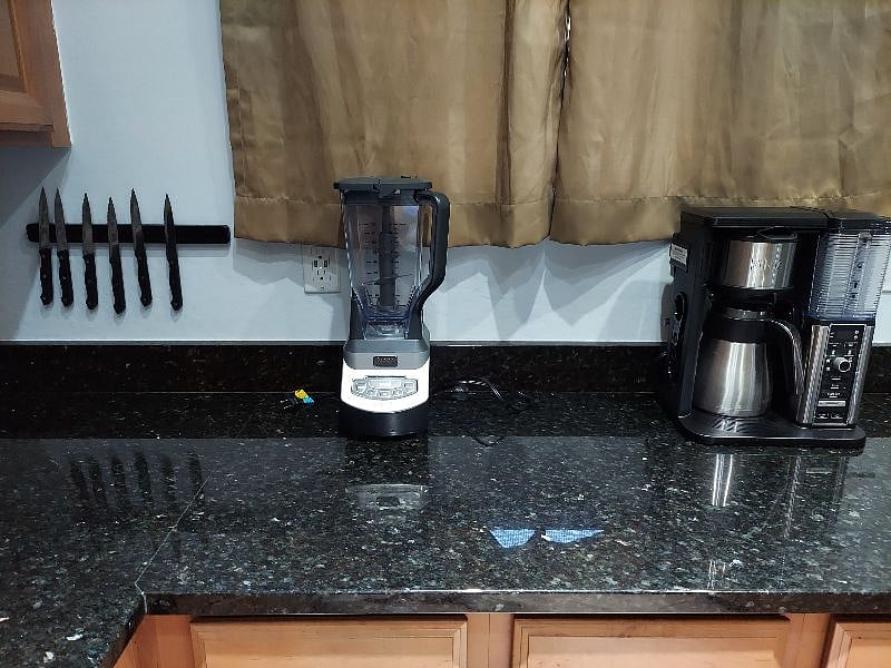 Coffee pot, coffee grinder, blender, instant pot, single and double burner, skillet, Misc pots and pans are included. As well as dishes and utensils.