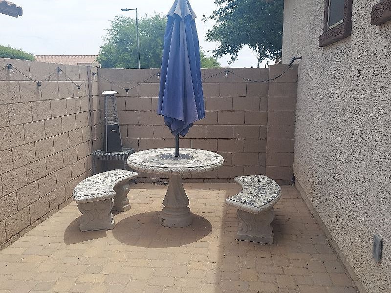 Outdoor seating area and umbrella, also working tabletop fire feature.