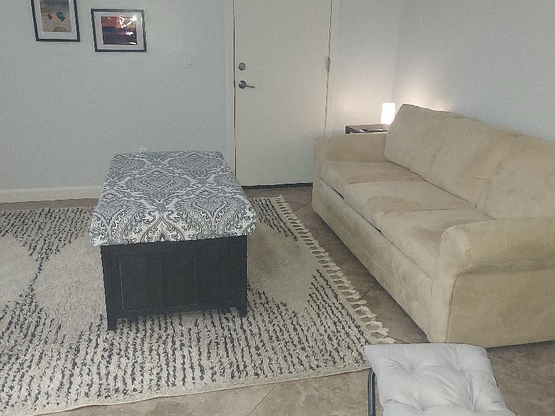 Coffee table stores excess throw blankets while cozying up to watch tv.