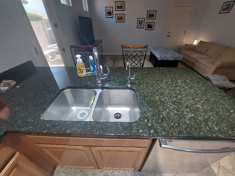 Sink and garbage disposal and view of the living area.