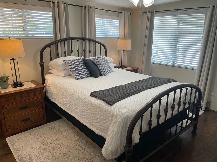 Primary bedroom with black out curtains.