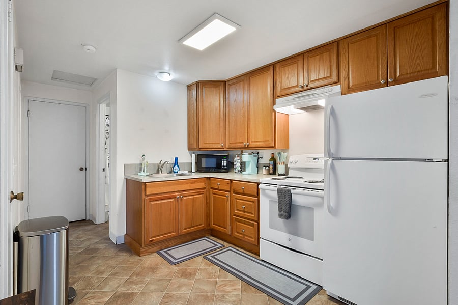 Well stocked kitchen with full size refrigerator and stove oven combo.
