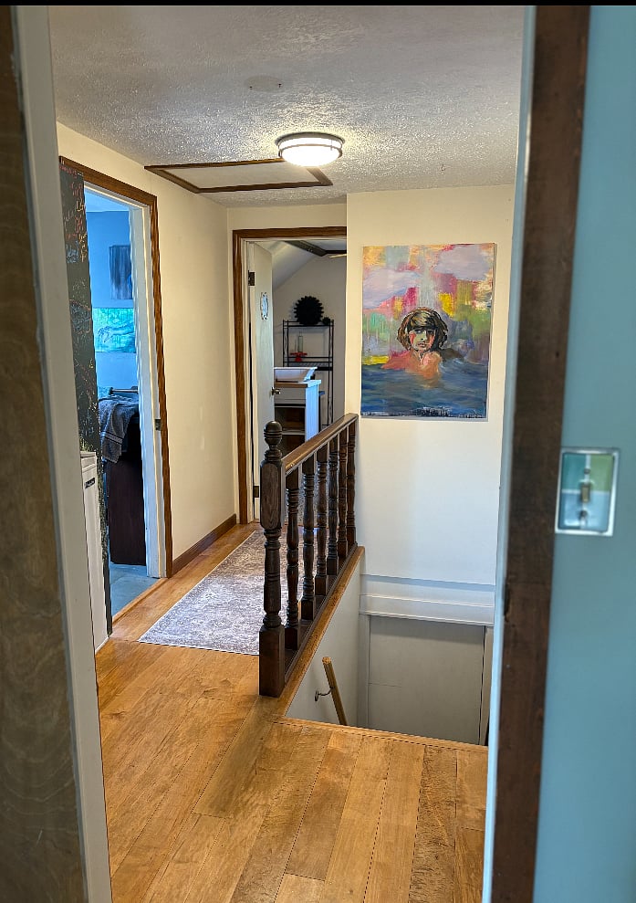 Hallway to bathroom, kitchen, extra living area, balcony and entrance.