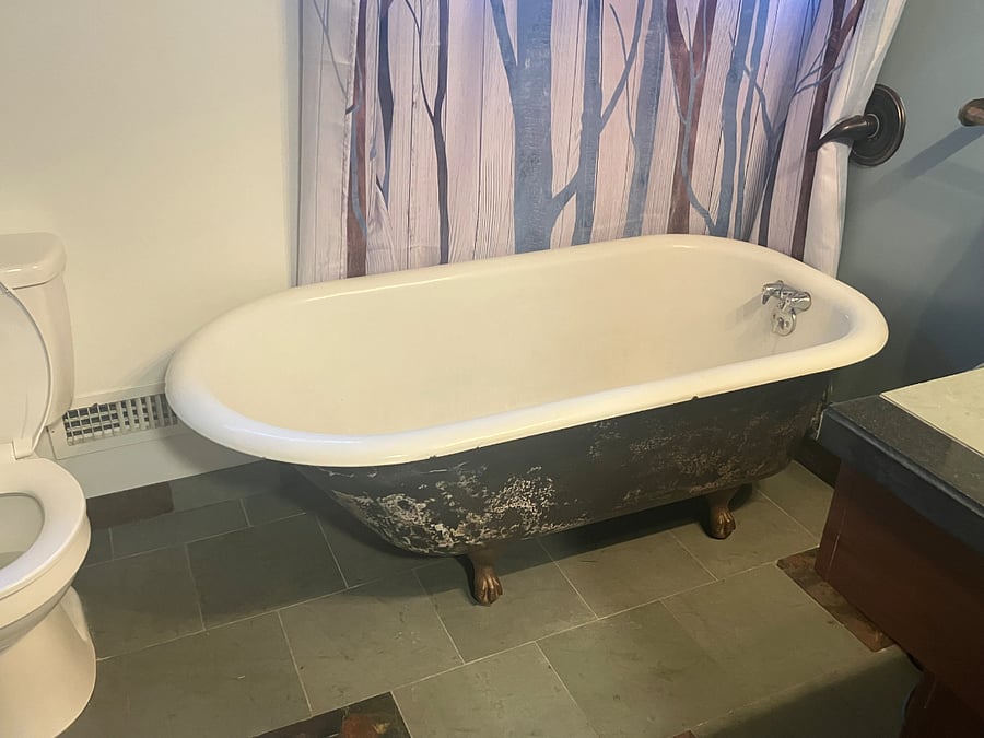 Deep clawfoot bathtub/shower combo.