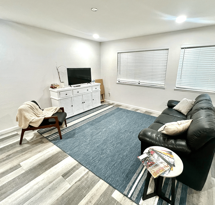 A comfortable living room with smart T.V provides endless entertainment.
