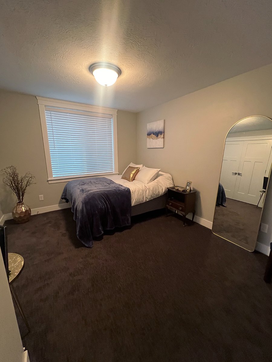 Your bedroom complete with a queen TempurPedic bed, full-length mirror and TV.