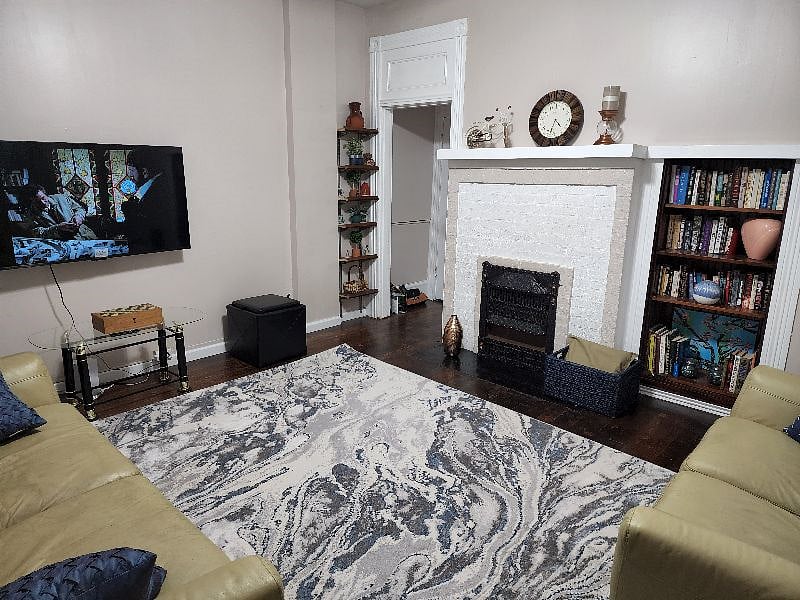 Another view of living room and wall mounted tv