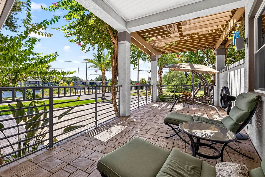front terrace w/ double swinging lounge chairs and sun shade