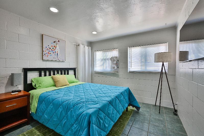 The queen master bedroom is bright and colourful.