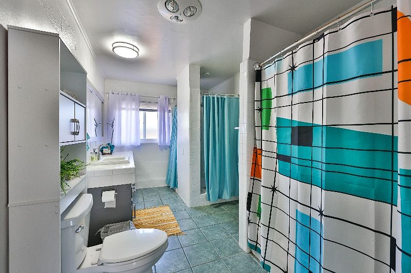The bathroom is stocked with essential toiletries and fluffy towels.