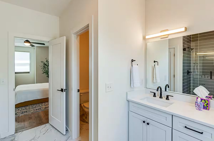 Primary bath on 3rd floor off primary bed-- double sinks, spacious closet, toilet separated with door