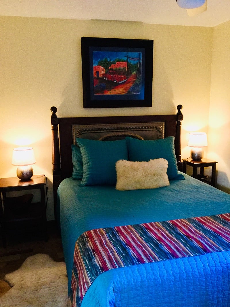 Qn size bed, wood and brass headboard, stylish linens