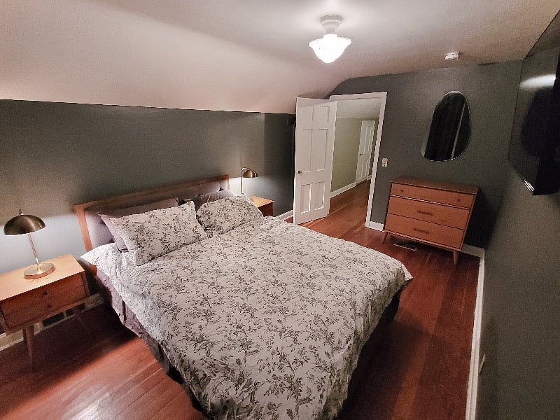 The upstairs bedroom features a queen bed and another Roku TV, including all your favorite streaming apps.
