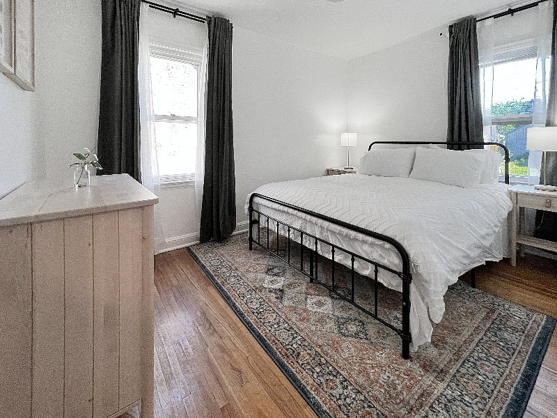 Bedroom #1, on the main level, includes plenty of natural light, a closet, and dresser.