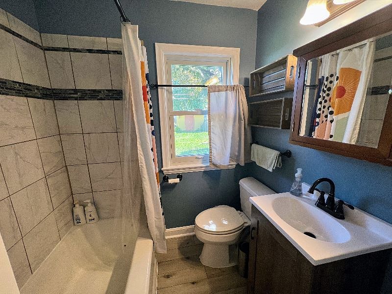 The bathroom is on the main level and includes a shower and bathtub, toilet with a bidet, as well as basic supplies like towels, shampoo, and conditioner. A hair dryer and iron are also available.