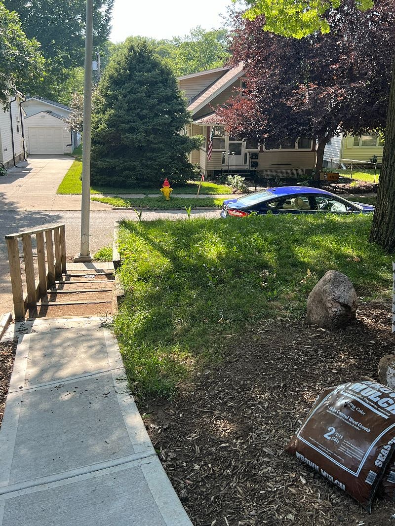 Private sidewalk with street-side parking right next to it.