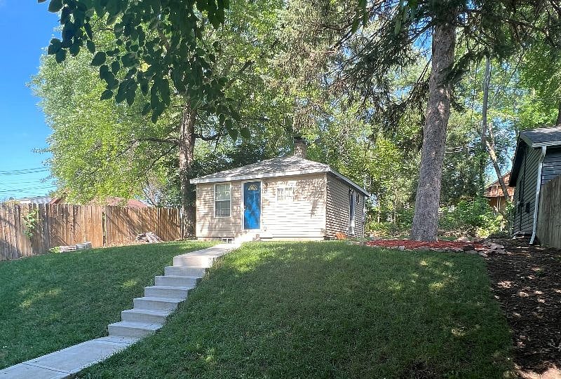 Secluded backyard with private sidewalk.