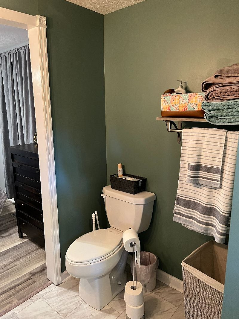 Bathroom has multiple towel racks and storage areas.