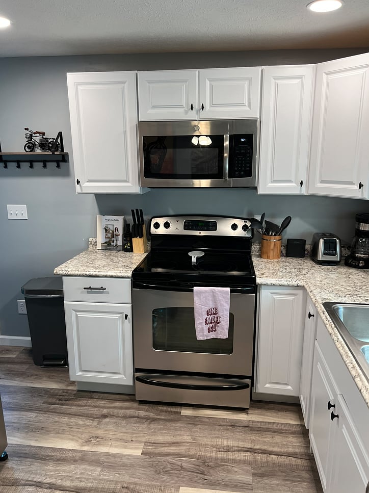 Brand new cabinets, flooring, & countertops. GE appliances. Electric glasstop stove.