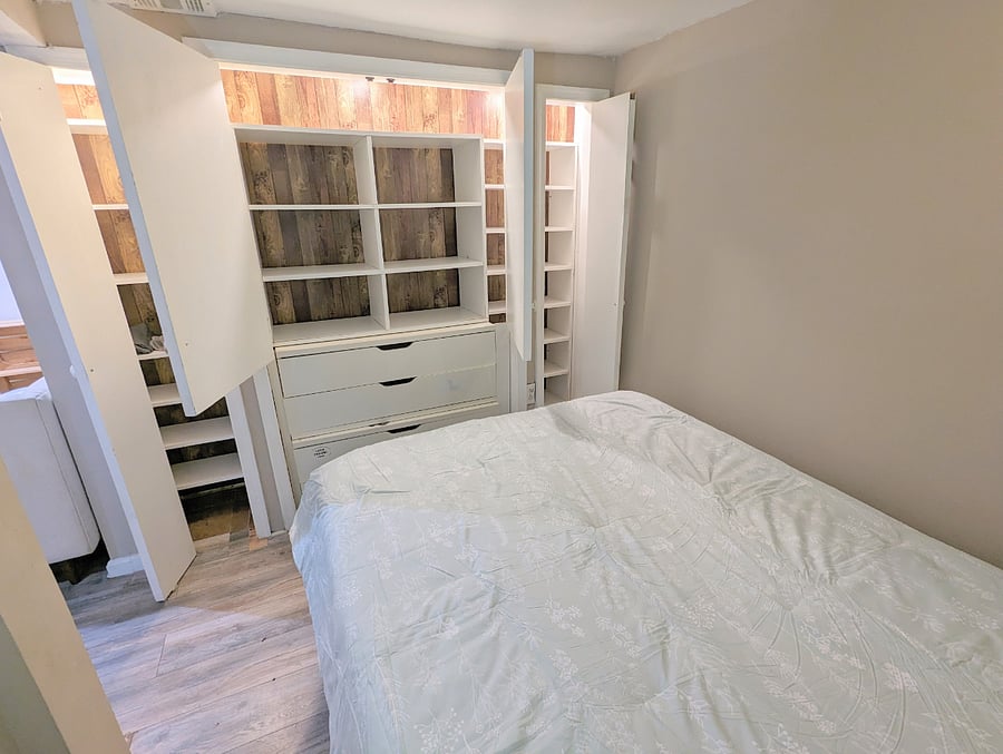 English Basement's Queen bed and vast storage