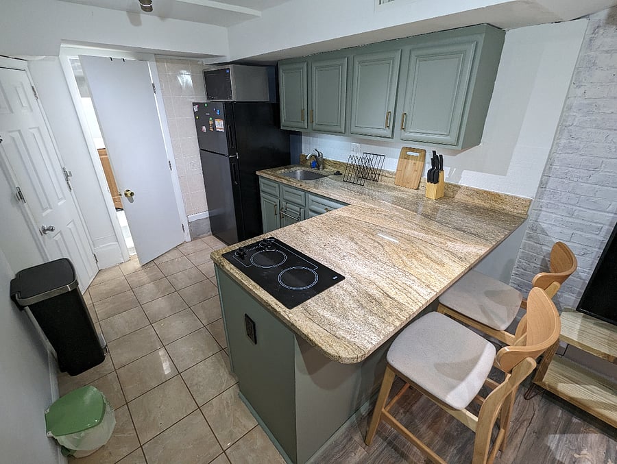 English Basement Kitchenette: Full fridge, kitchen sink, and hot plate