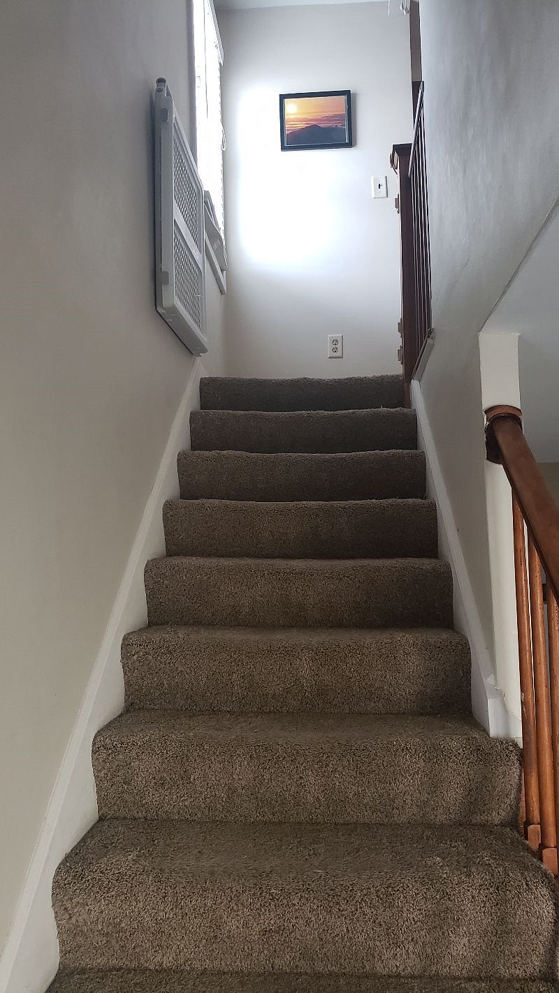Stairs to upstairs bedrooms/bathroom.