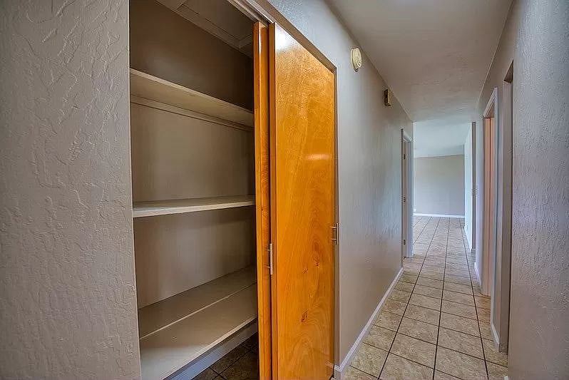 Looking towards the living room from the end of the hallway between the two bedrooms.