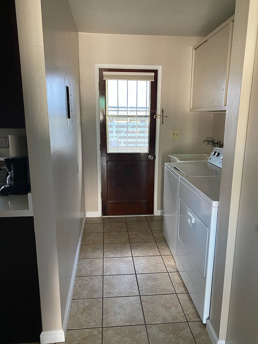 Side door exit. Laundry room behind the kitchen.