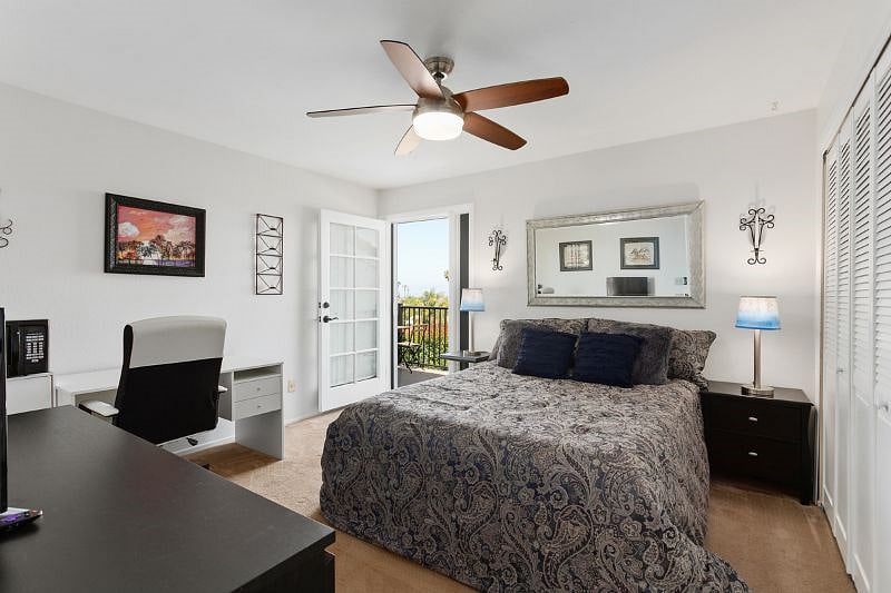2nd bedroom with entry to side deck. Carpet has been replaced with plank flooring.